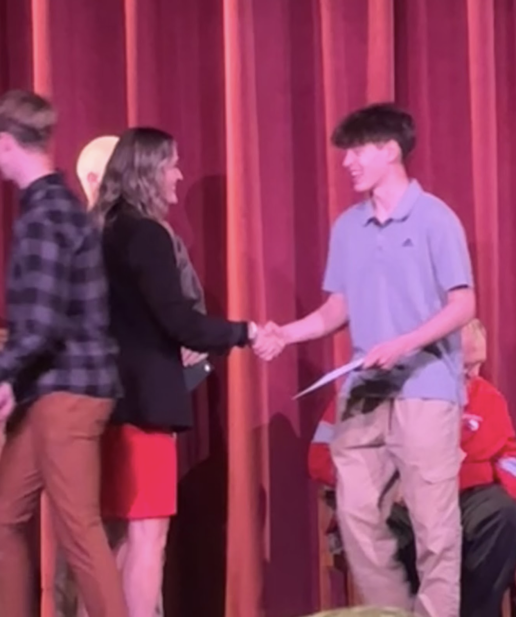 During the fall awards banquet, junior Jack Dybwad accepts his awards with his team for this year's tennis season. Dybwad received his award for making it to state finals from the principal, Mrs. McMahn, as he only lost two matches all year with senior doubles partner Russel Dean. “I was very happy with the season and looking back I wouldn't have had it any other way,” Dybwad said. “Our team as a whole was glad with the outcome and are looking forward to next season.”